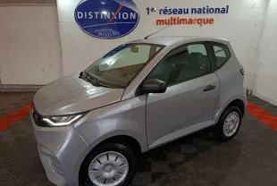 Aixam Ambition 0.5 City Pack gris clair en 3/4 avant droit, avec rétroviseur caméra côté conducteur visible.