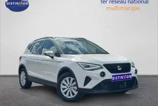 SEAT Arona blanc Candy avec toit gris Magnétique, vue 3/4 avant droit, jantes alu et calandre noire distinctive.