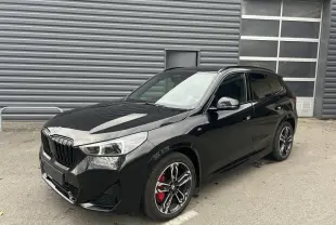 BMW X1 XDRIVE 20D M SPORT noir Black Saphire vue 3/4 avant avec jantes sport et étriers rouges visibles