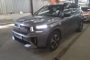 Citroën C3 Aircross électrique gris Mercury avec toit noir, vue 3/4 avant droit en intérieur d'atelier.