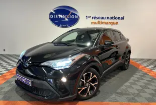 Toyota C-HR Hybride noir métal en 3/4 avant droit, phares LED allumés et jantes bi-ton distinctives.