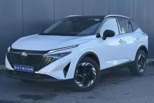 Nissan Qashqai 2025 blanc nacré avec toit noir, vue 3/4 avant droit, jantes alliage noires et calandre distinctive.