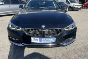 Vue avant d'une BMW Série 4 Gran Coupé 418 da noir métal de 2018 avec calandre double haricot et phares LED allumés.