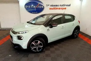 Citroën C3 PureTech 82 vert vue 3/4 avant droit, avec jantes noires et toit noir contrasté dans un showroom.