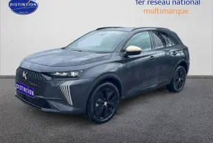 Vue 3/4 avant d'un DS7 gris titane avec jantes noires et rétroviseurs blancs contrastants sur fond neutre.