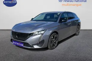Peugeot 308 SW Hybrid gris Artense métal vue 3/4 avant droit, avec calandre noire et jantes alliage bicolores.