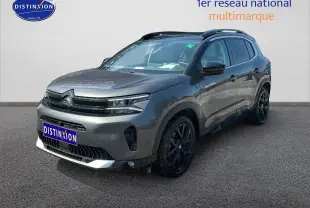 SUV Citroën C5 Aircross gris platinium en 3/4 avant droit avec jantes noires et barres de toit visibles.