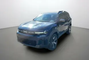 Dacia Bigster Hybrid 155 Journey City bleu indigo en 3/4 avant droit avec barres de toit et jantes alu.