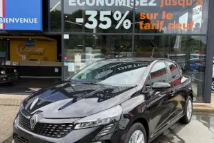 Renault Clio noire en 3/4 avant droit, stationnée devant un concessionnaire Distinxion multimarque.