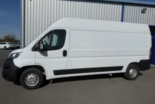 Vue de profil côté gauche d’un Opel Movano Fourgon blanc 2023 avec porte latérale coulissante et jantes acier.