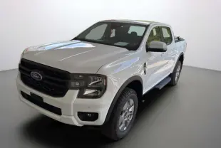 Ford Ranger blanc glacier en 3/4 avant droit, avec calandre noire et jantes alu 18 pouces tout terrain.